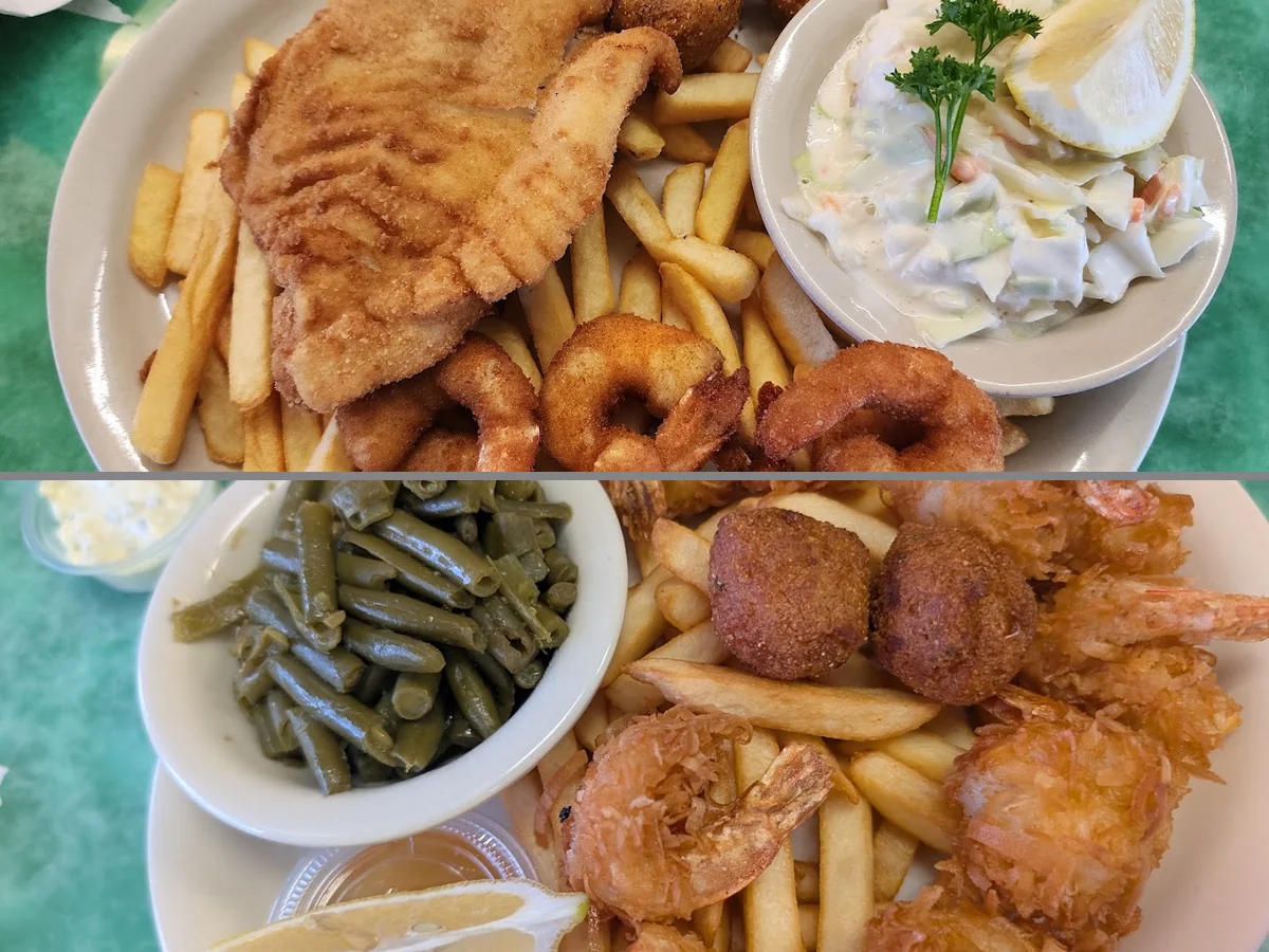 Seafood plates under ocean mural walls.