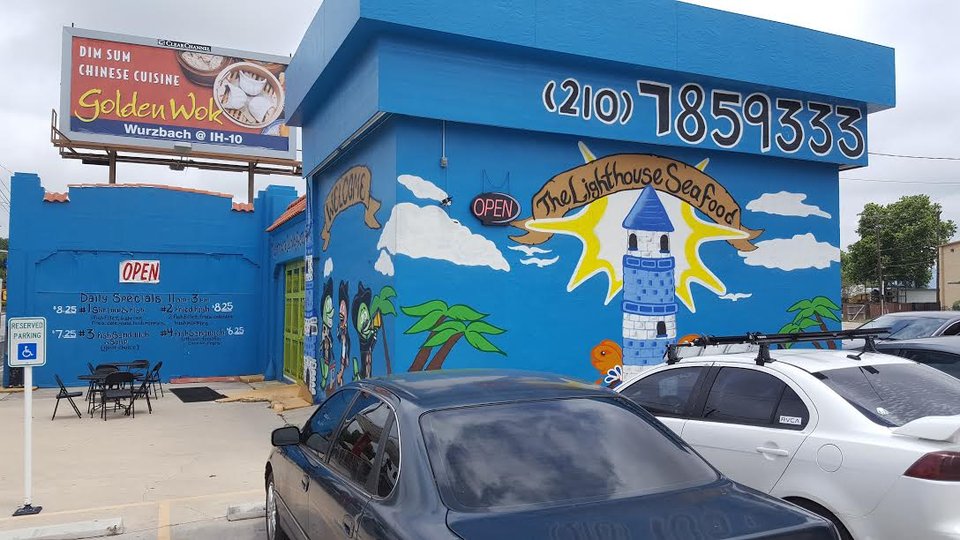 Seafood plates under ocean mural walls.